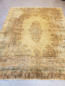 botton left view of a kerman room sized rug, heavily muted colors and lots of patina