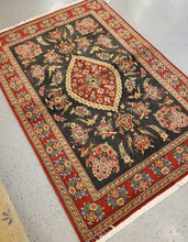 Load image into Gallery viewer, Area Rug from Iran with a Black field and Red border and floral and birds Geometric pattern