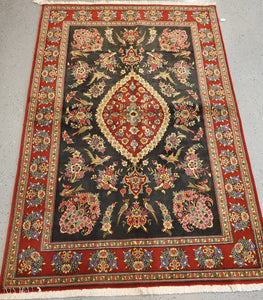 Iranian hand-knotted wool carpet black field white fringe