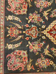 Flowers and birds and flowers sitting inside the Black field of a Persian Hand Knotted Rug made in Qom Iran