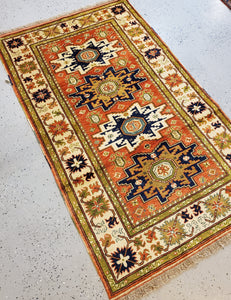 full view of this Turkish made Caucasion rug from top right or lighter side of the rug