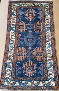 a hand knotted rug runner with 3 borders and Blue field Floral and geometric shapes